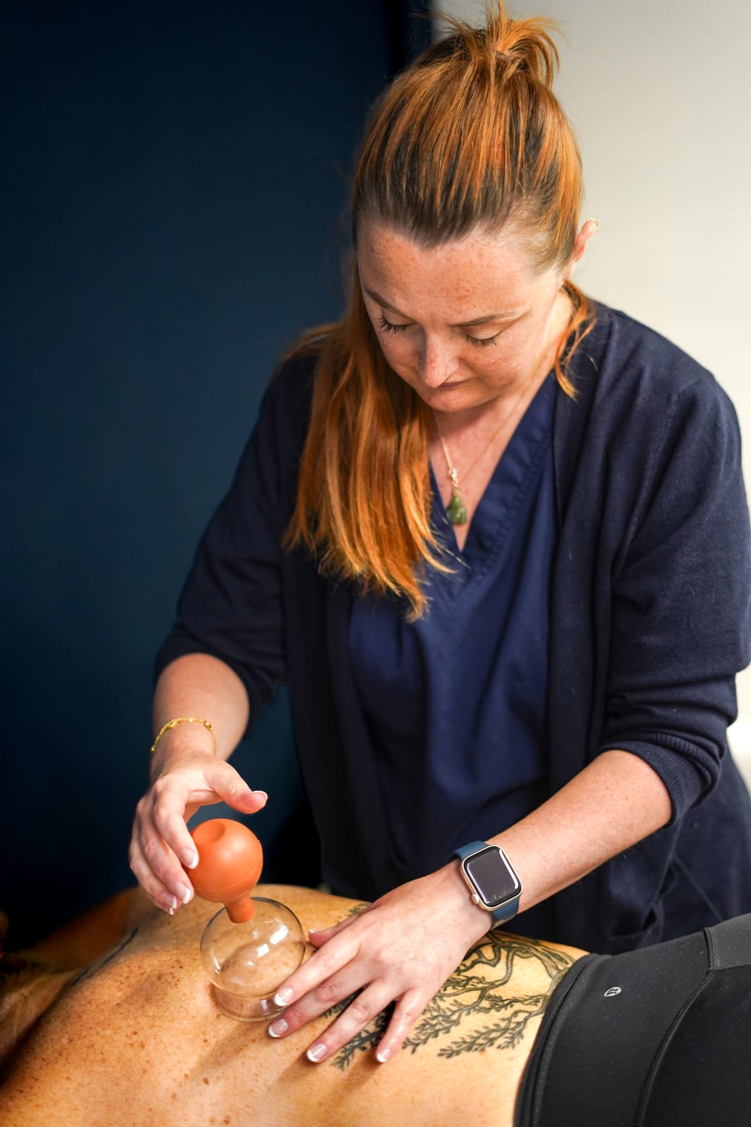 Laura applying cupping therapy at her Boldmere clinic